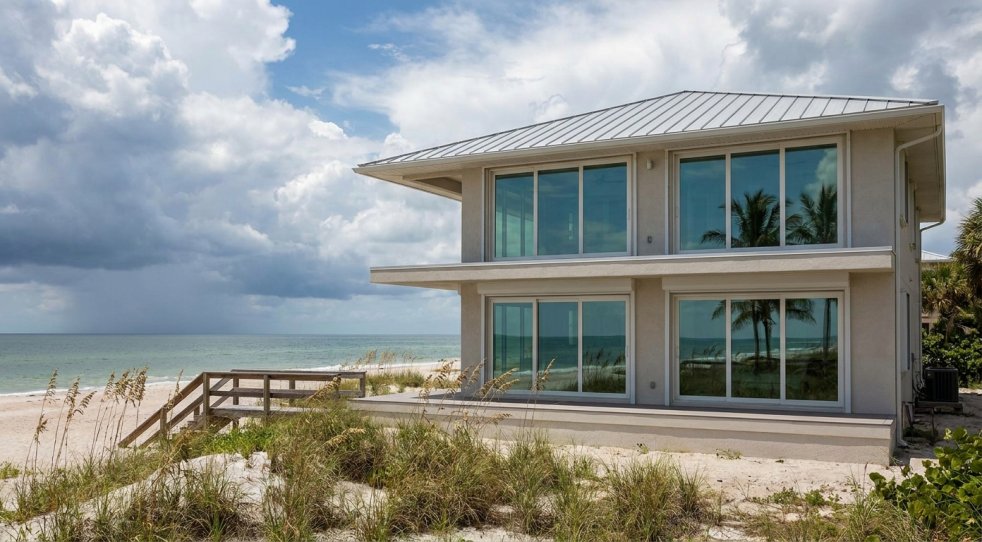 Coastal Florida home with large impact-resistant windows overlooking the beach
